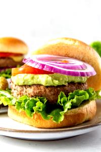 1 Hamburger Turkey Burger with Condiments and Vegetables on Bun