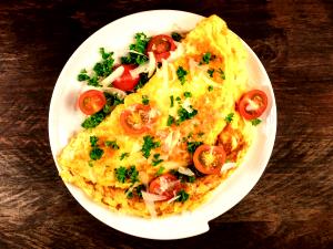 1 Large Egg Omelet or Scrambled Egg with Cheese, Ham or Bacon and Tomatoes