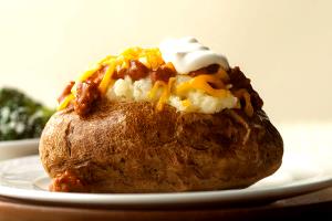 1 Oz Baked Potato Topped with Cheese Sauce and Chili