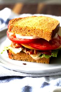 1 serving (7 oz) Bacon Turkey Bravo Sandwich on Tomato Basil Bread (Half)
